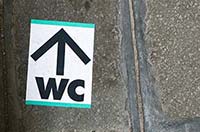 Public WC pavement sticker in Venice